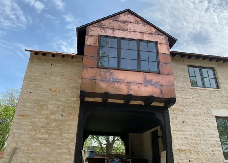 Copper metal panel facade on a stone building for Metal Roof Coating in Cottage Grove